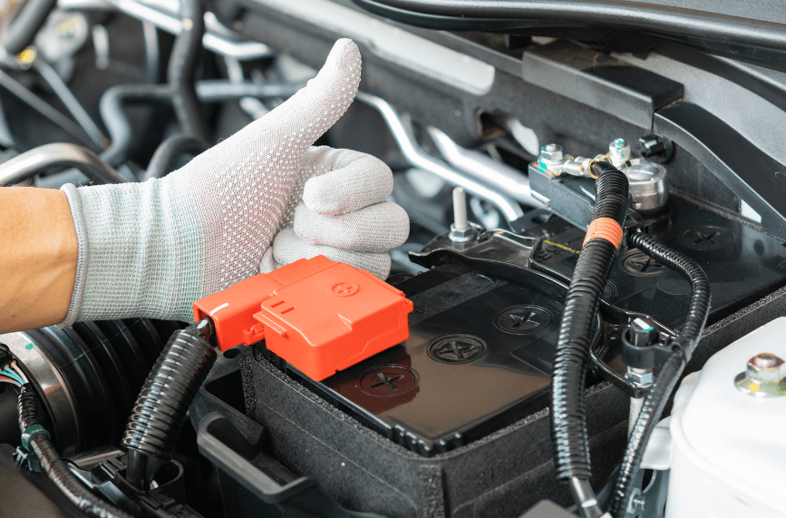 man checking car battery for maintenance