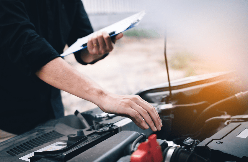 guy inspecting car