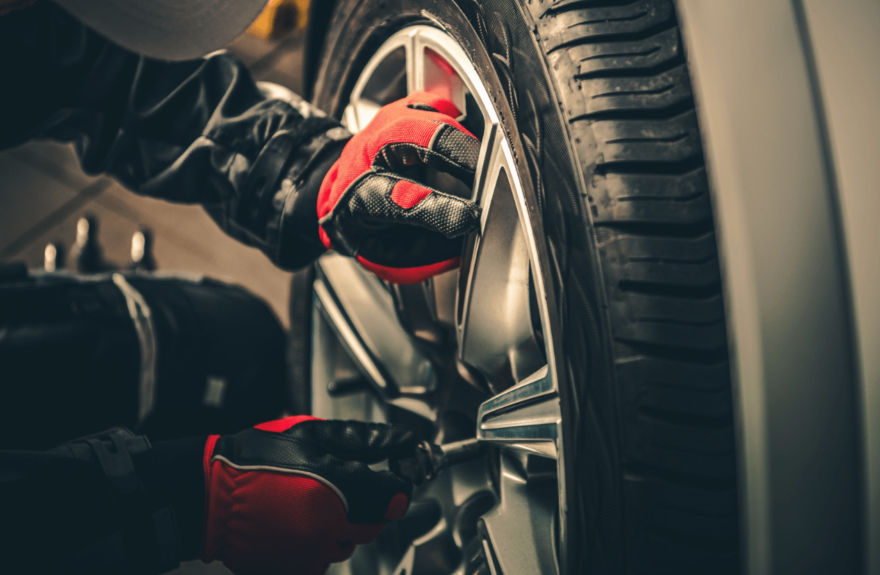 man checking car tires pressure