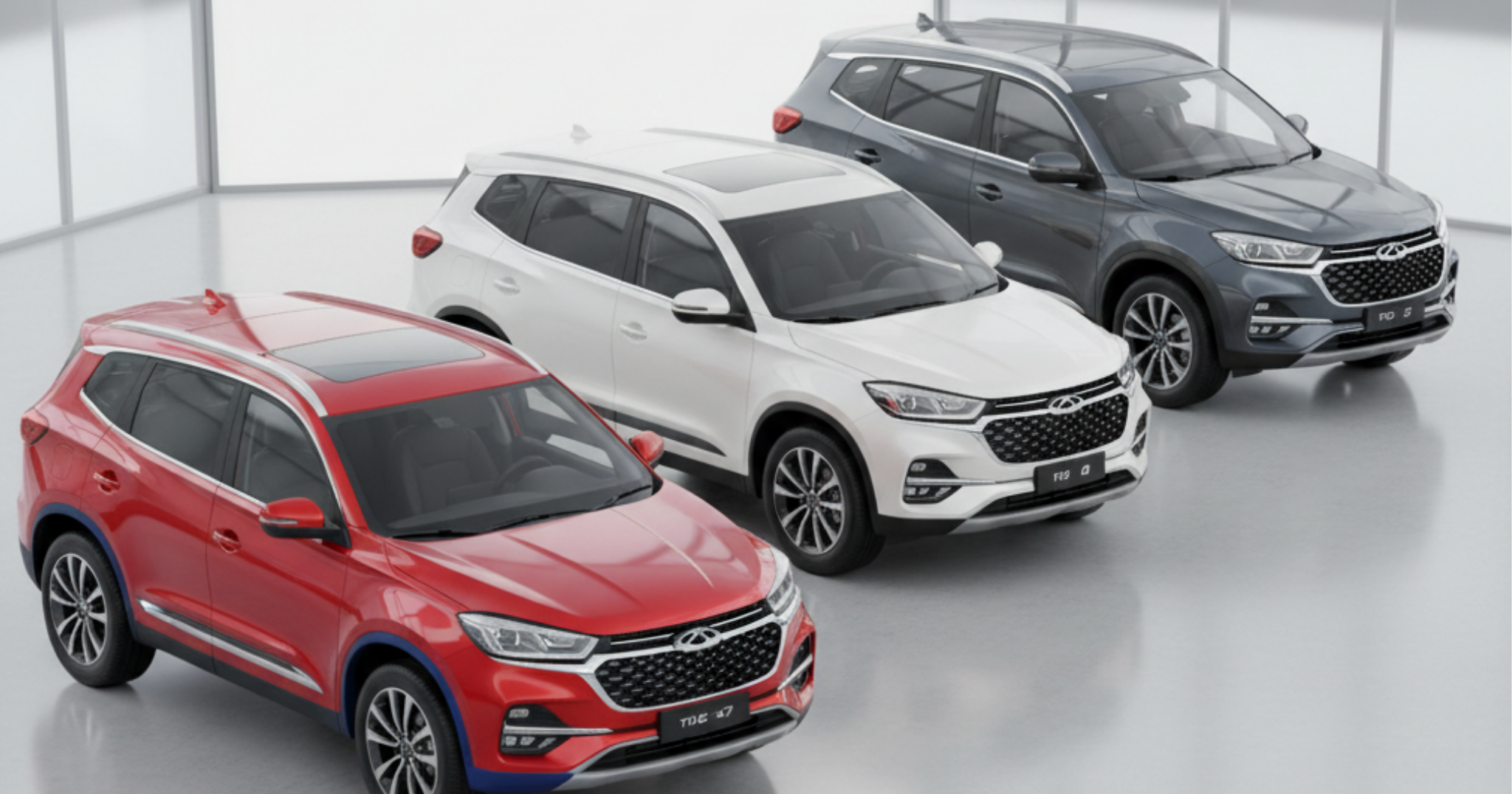 A line-up of three Chery Tiggo SUVs in red, white, and dark gray, positioned diagonally in a modern showroom setting with large windows.
